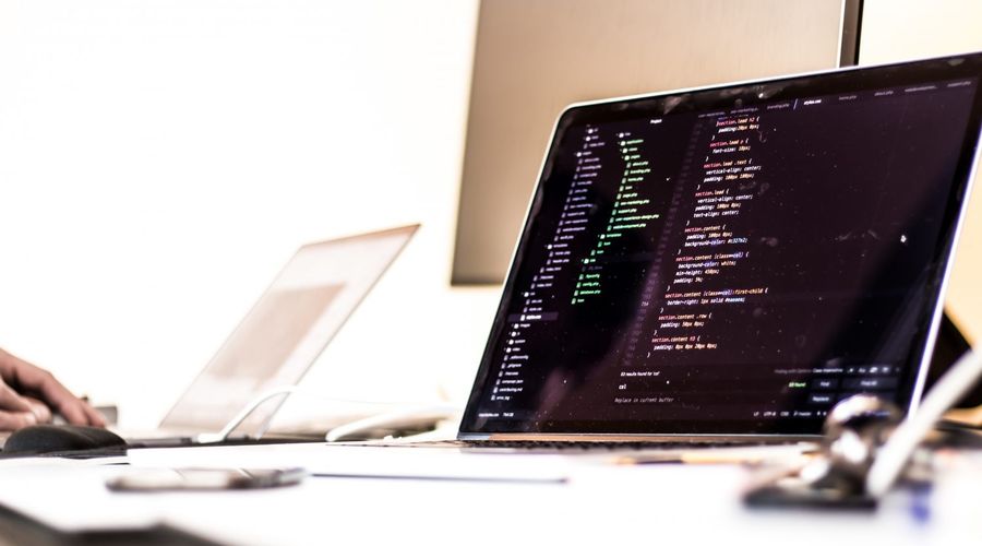 Shallow focus photo of a laptop running a code editor with CSS on the screen