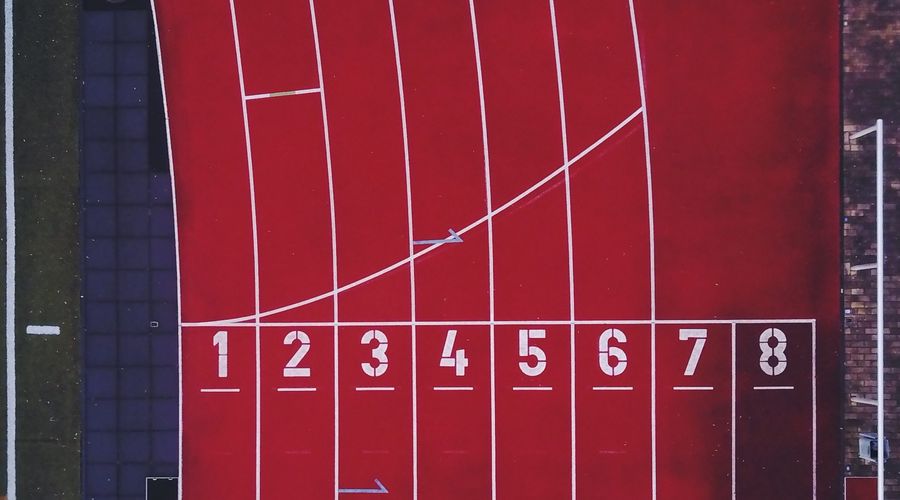 Top-down photo of the numbered lanes on a running track